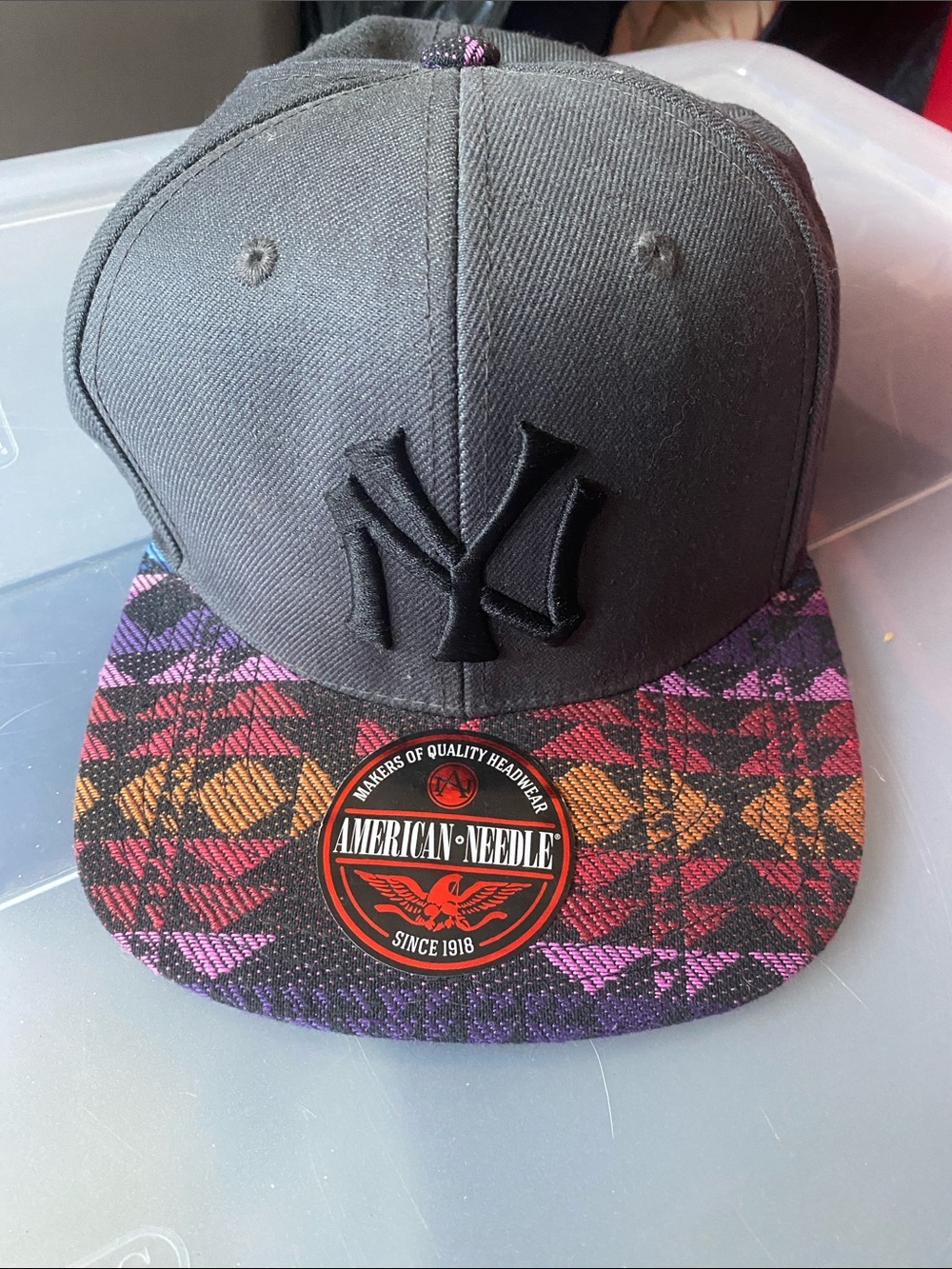 American Needle Black Snapback with Purple Pink Orange Plaid Visor